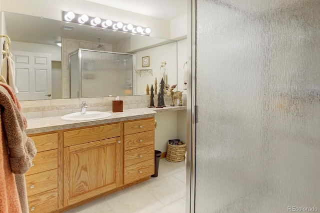 full bath with tile patterned flooring, vanity, and a stall shower