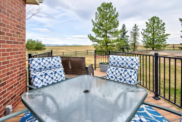 exterior space featuring a rural view, a yard, and outdoor dining area
