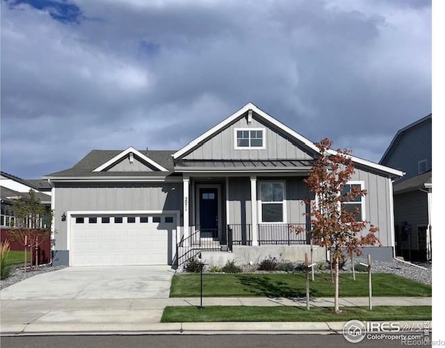 view of front of property with a garage and a front lawn