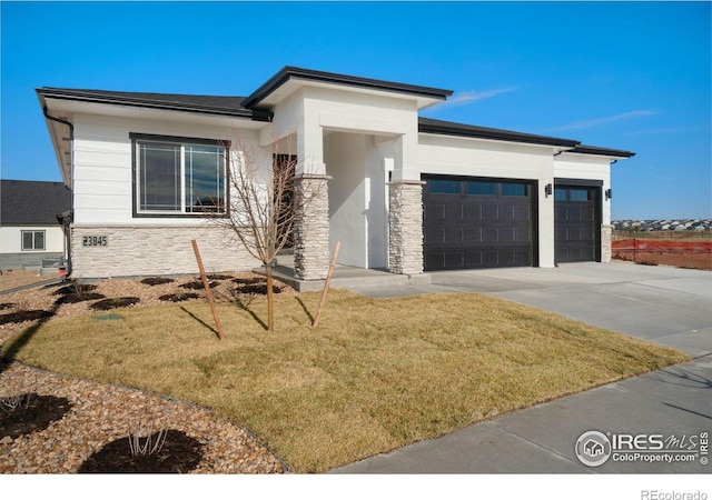 prairie-style house with a garage and a front lawn