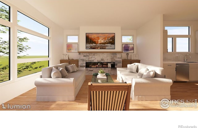 living room with sink, a fireplace, and light wood-type flooring