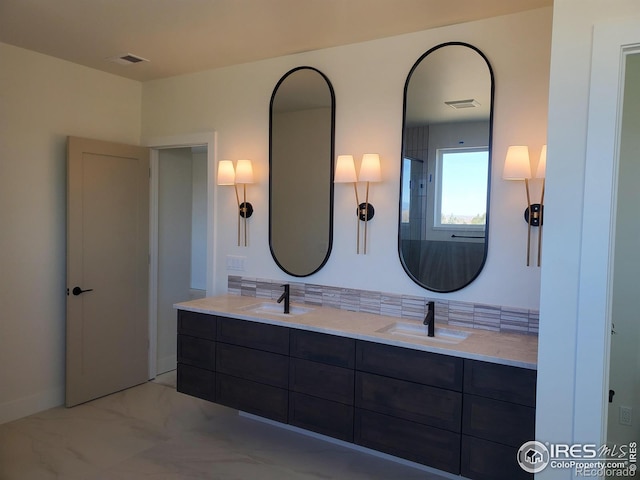 full bathroom featuring double vanity, visible vents, and a sink