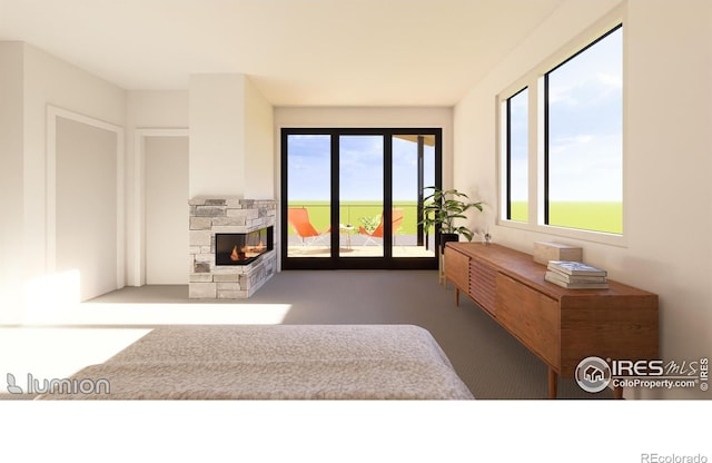 bedroom with access to outside, carpet flooring, and a stone fireplace