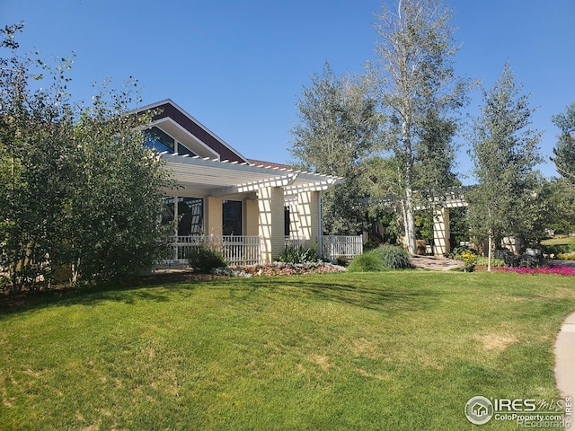 view of front of house with a pergola and a front yard