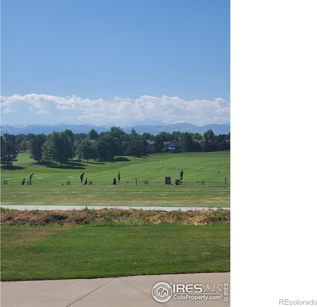 view of property's community featuring a mountain view and a lawn