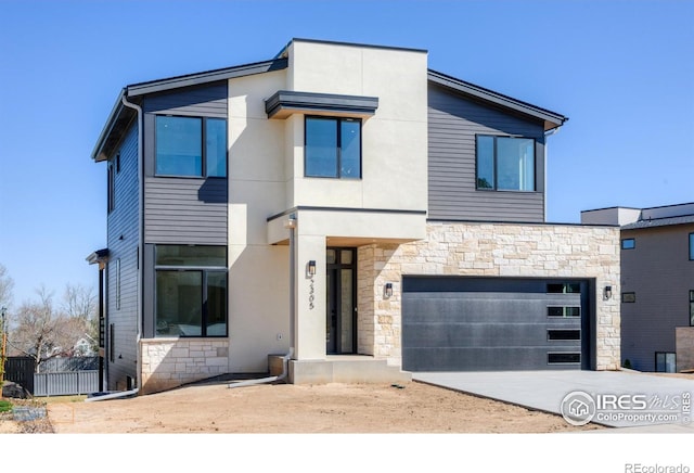 2305 Glacier Ct, Lafayette, CO 80026 - contemporary home featuring stone siding, concrete driveway, an attached garage, and stucco siding
