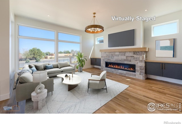 2305 Glacier Ct, Lafayette, CO 80026 - living room featuring a fireplace, healthy amount of natural light, and baseboards