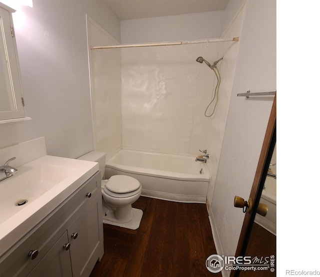 full bathroom with bathtub / shower combination, toilet, hardwood / wood-style flooring, and vanity