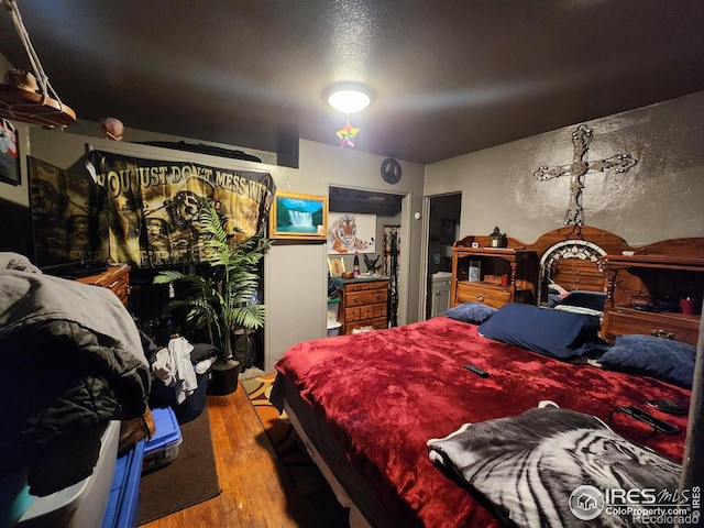 bedroom with hardwood / wood-style floors