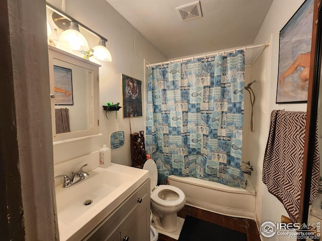 full bathroom with vanity, toilet, and shower / bath combo with shower curtain