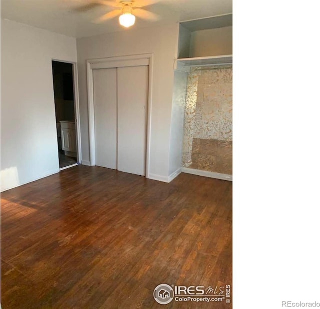 unfurnished bedroom with ceiling fan, dark wood-type flooring, and a closet