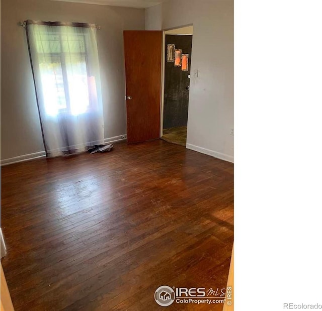 unfurnished room featuring dark hardwood / wood-style floors