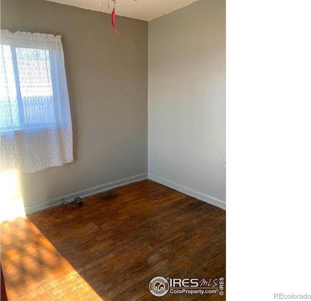 empty room featuring dark wood-type flooring