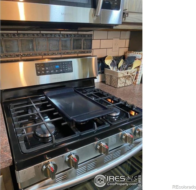 details with backsplash and stainless steel range with gas stovetop