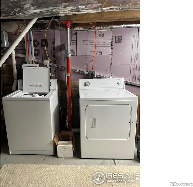 laundry area featuring washing machine and clothes dryer