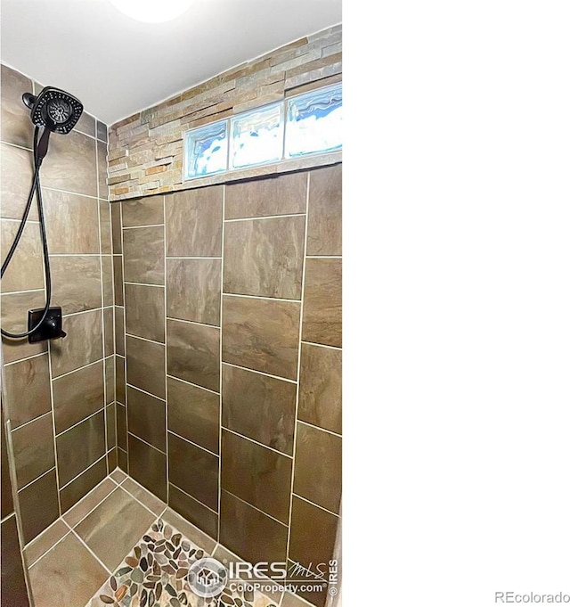 bathroom with tiled shower