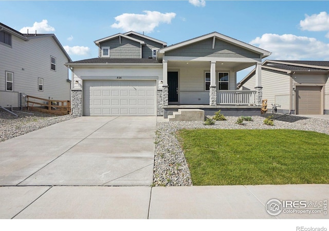 craftsman-style home with a garage, a porch, and a front lawn