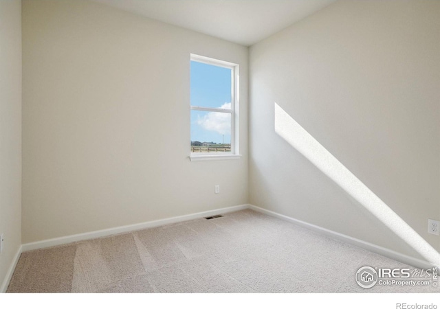 carpeted empty room with visible vents and baseboards