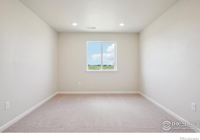 empty room with recessed lighting, visible vents, carpet floors, and baseboards