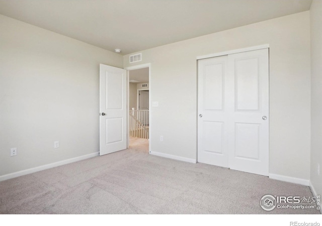 unfurnished bedroom featuring baseboards and carpet flooring