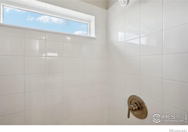 interior details with a tile shower