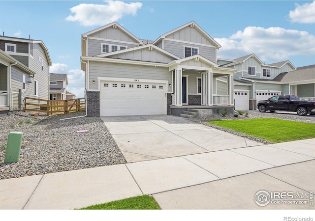 craftsman inspired home with brick siding, an attached garage, board and batten siding, fence, and driveway