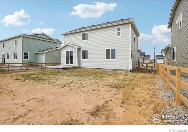 rear view of house featuring a fenced backyard, a yard, and a patio