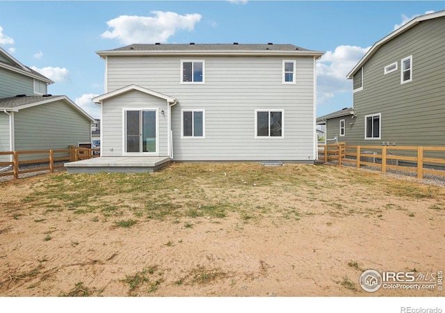 rear view of house featuring a patio area, a fenced backyard, and a yard