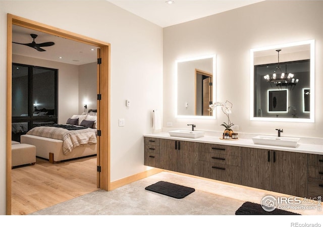 bathroom with vanity, hardwood / wood-style flooring, and ceiling fan