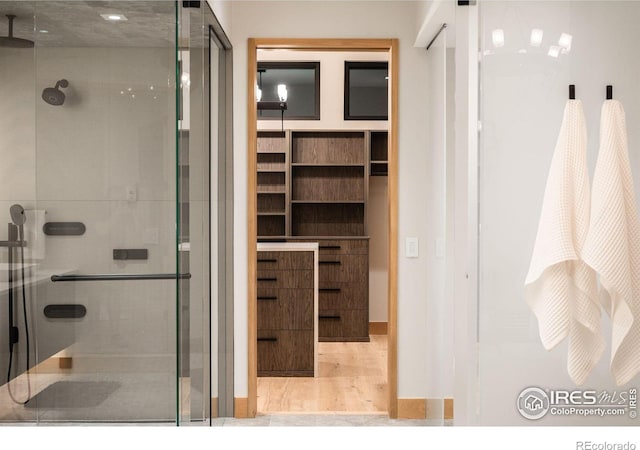 bathroom featuring an enclosed shower and hardwood / wood-style floors