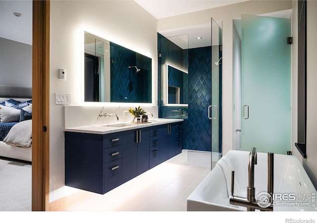 bathroom featuring vanity, a shower with shower door, and tile patterned floors