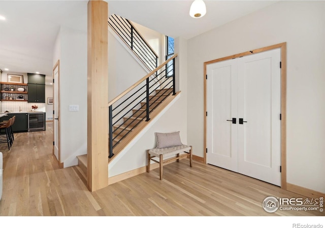 entryway featuring wine cooler and light hardwood / wood-style flooring