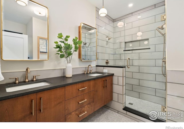 bathroom with tile flooring, a shower with door, and dual bowl vanity