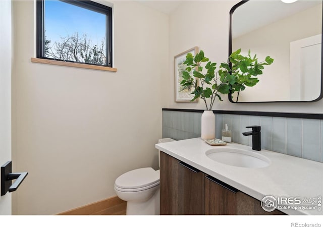 bathroom with backsplash, oversized vanity, and toilet