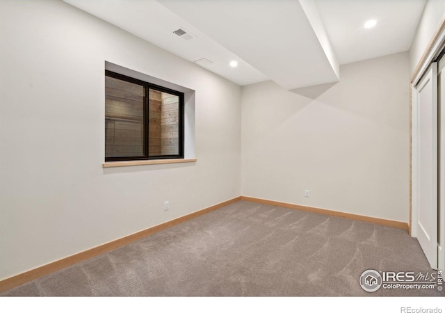 unfurnished room featuring light carpet