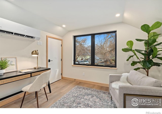 office space with an AC wall unit, lofted ceiling, and light hardwood / wood-style flooring