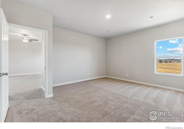 carpeted empty room featuring ceiling fan