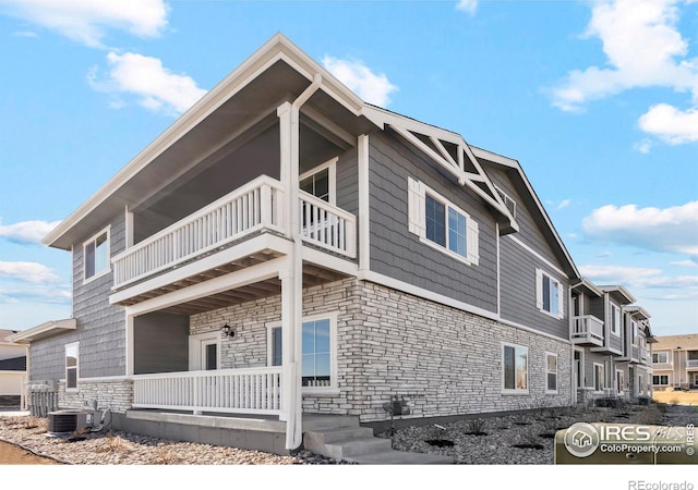 view of property exterior with a balcony and central air condition unit