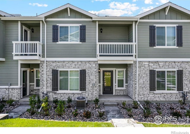 townhome / multi-family property featuring a balcony and cooling unit