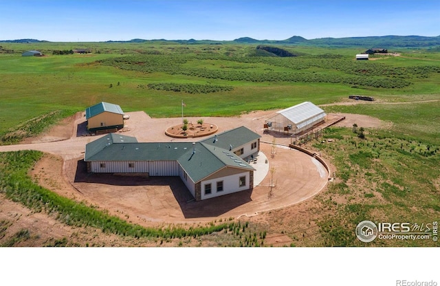 birds eye view of property with a mountain view and a rural view