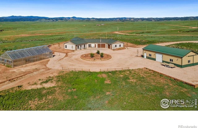 birds eye view of property featuring a mountain view and a rural view