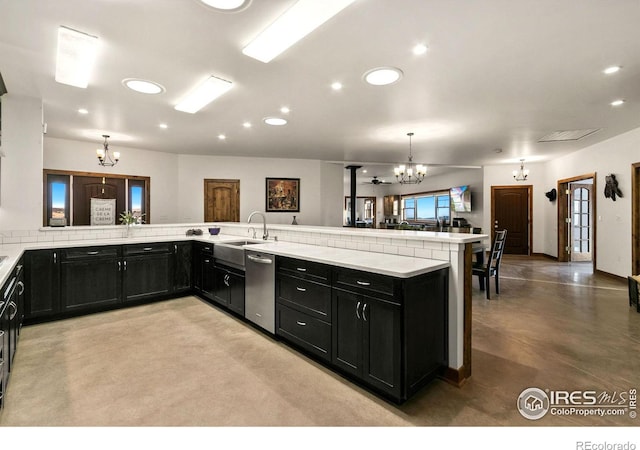 kitchen with dishwasher, sink, kitchen peninsula, a chandelier, and decorative light fixtures