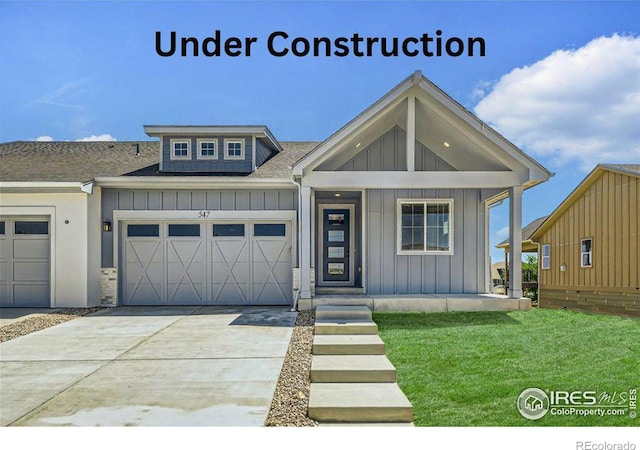 view of front of property with a garage and a front yard