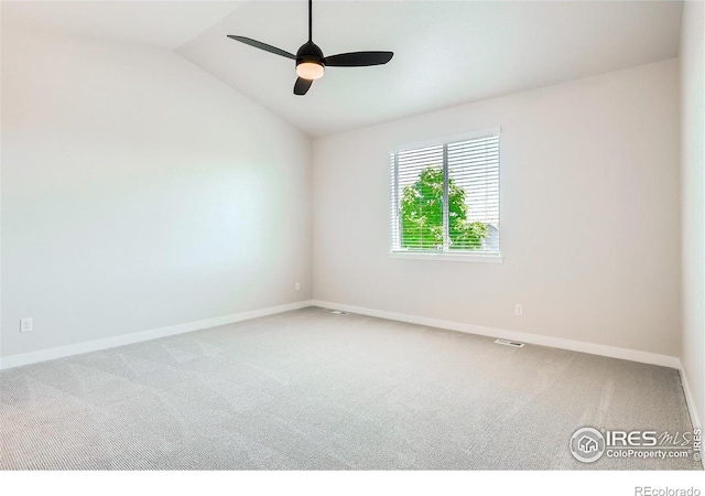 carpeted empty room with lofted ceiling and ceiling fan