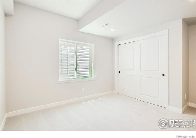 unfurnished bedroom with a closet and carpet floors