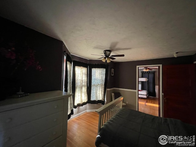 bedroom with light hardwood / wood-style flooring and ceiling fan