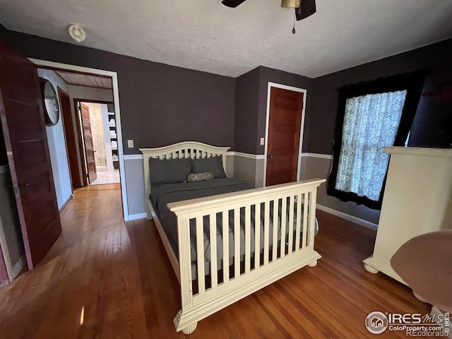 bedroom featuring ceiling fan and dark hardwood / wood-style flooring