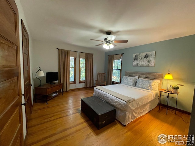 bedroom with ceiling fan and light hardwood / wood-style flooring