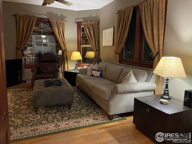 sitting room featuring hardwood / wood-style floors and ceiling fan