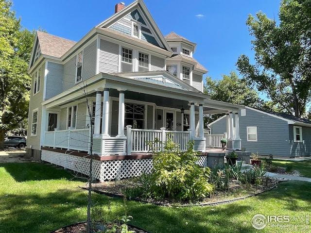 victorian house with a porch and a front yard